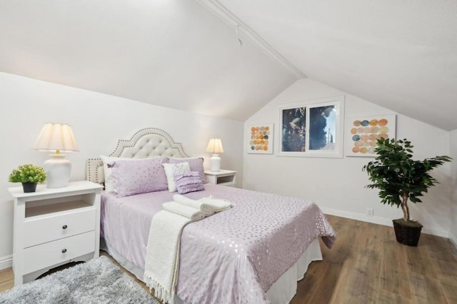 bedroom featuring lofted ceiling and hardwood / wood-style floors