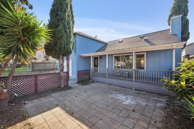 back of house featuring a patio and covered porch