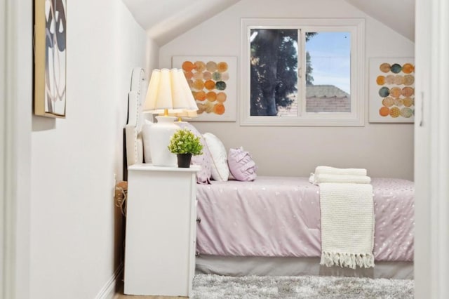 bedroom with lofted ceiling