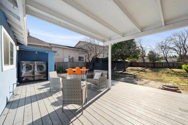 wooden terrace with an outdoor living space and washer and dryer