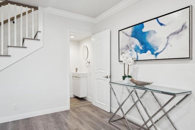 corridor with crown molding and light hardwood / wood-style flooring