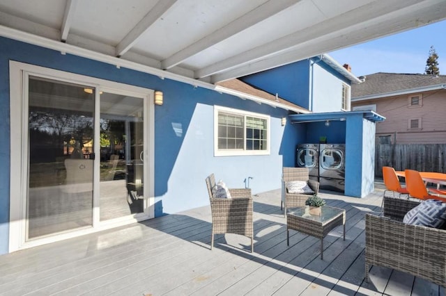 wooden terrace with outdoor lounge area and washer and dryer