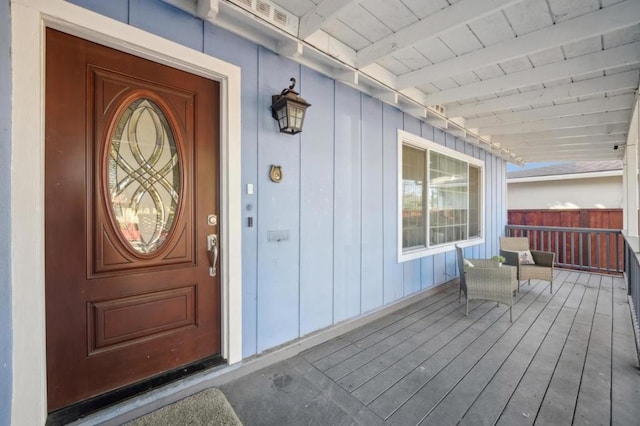 view of exterior entry with covered porch