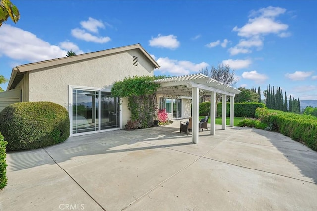 rear view of house with a pergola and a patio area