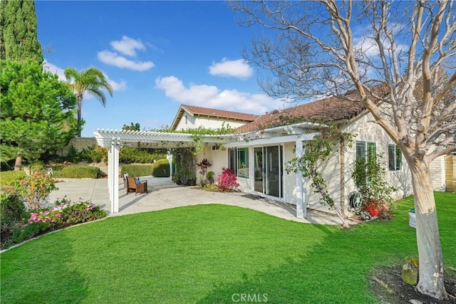 back of property featuring a yard, a pergola, and a patio