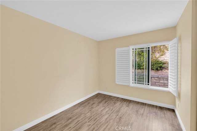 empty room with light hardwood / wood-style flooring