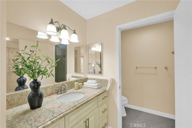 bathroom featuring vanity, tile patterned floors, a chandelier, and toilet