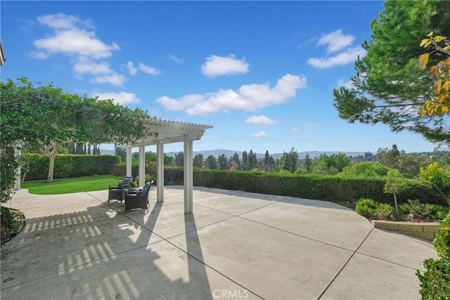 view of property's community featuring a mountain view, a pergola, a patio area, and a yard