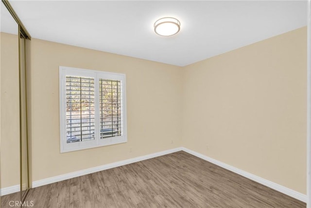 empty room with hardwood / wood-style floors