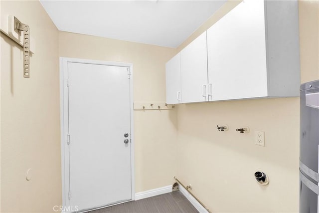 clothes washing area with cabinets and washer hookup