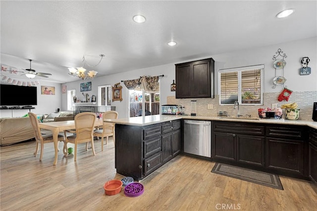 kitchen featuring sink, dishwasher, tasteful backsplash, light hardwood / wood-style floors, and kitchen peninsula