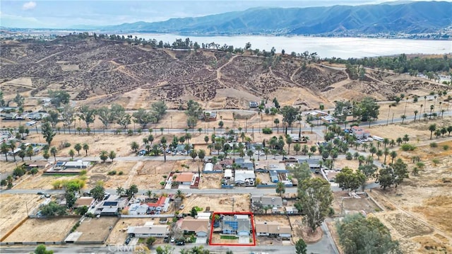 drone / aerial view featuring a water and mountain view