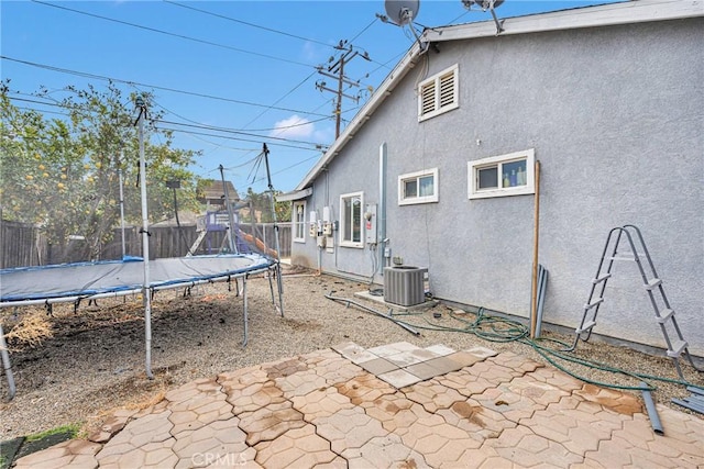 exterior space with central AC and a trampoline