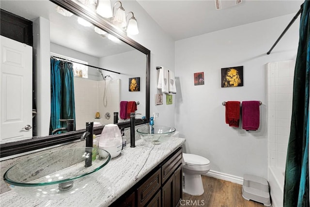 full bathroom featuring shower / bathtub combination with curtain, wood-type flooring, toilet, and vanity