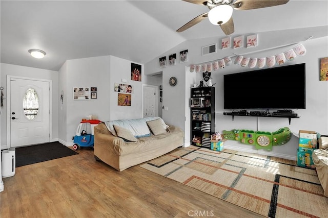 living room with wood-type flooring, lofted ceiling, and ceiling fan