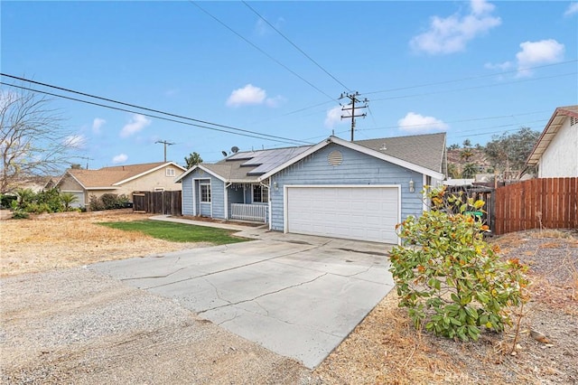 view of front of home featuring a garage and solar panels