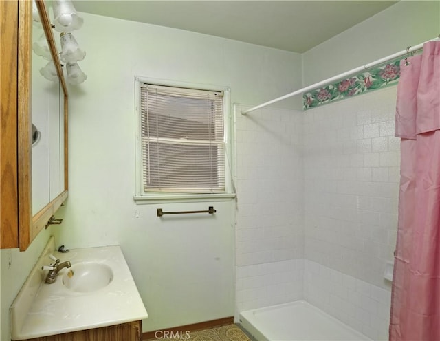 bathroom featuring vanity and curtained shower