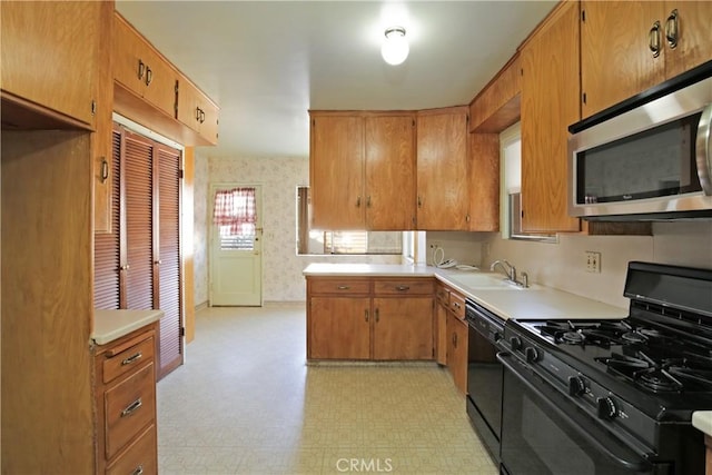 kitchen featuring sink and black appliances