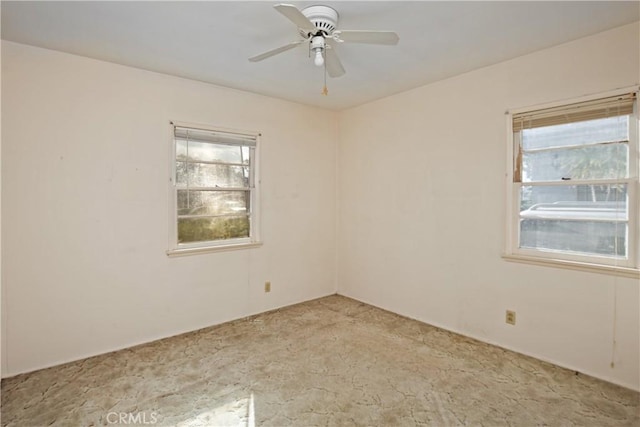 carpeted spare room with ceiling fan