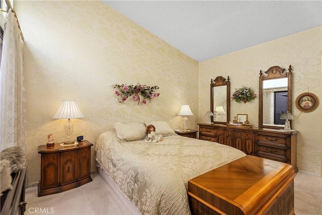 carpeted bedroom with lofted ceiling