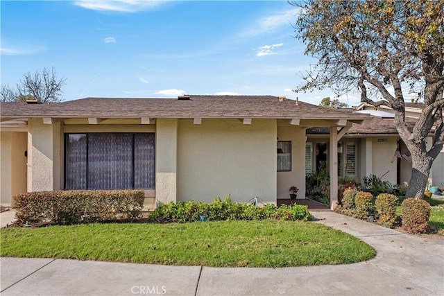 ranch-style home with a front lawn