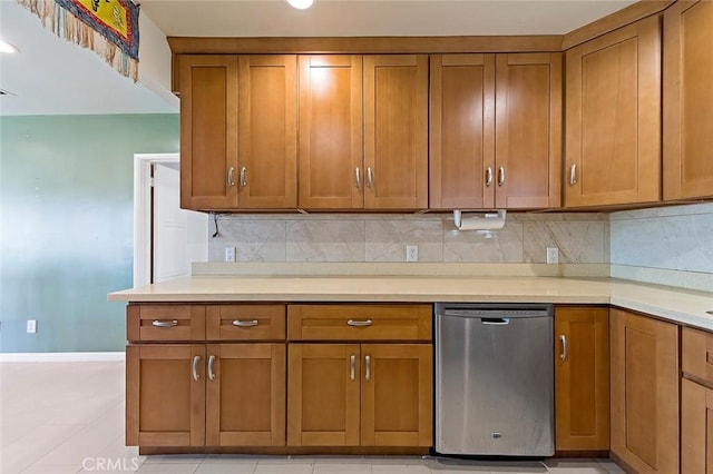 kitchen with tasteful backsplash, dishwasher, and light tile patterned floors