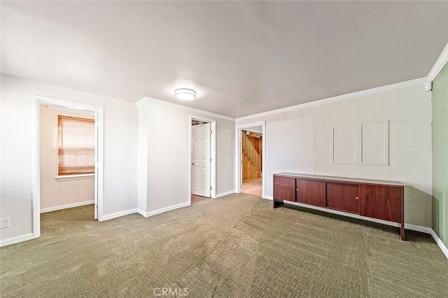 carpeted empty room featuring ornamental molding