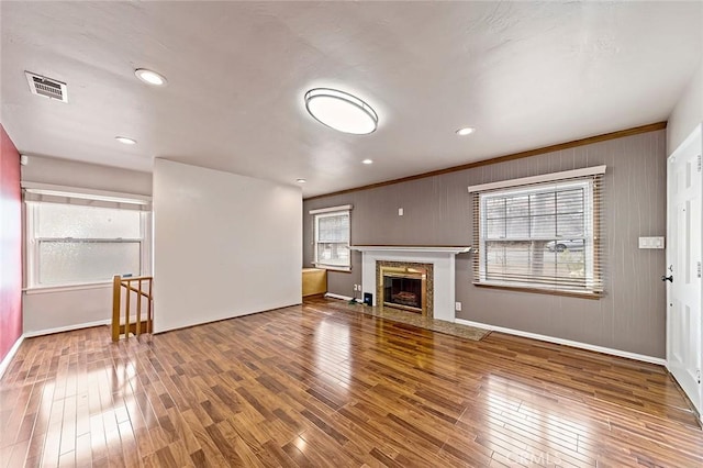 unfurnished living room with wood-type flooring and a high end fireplace