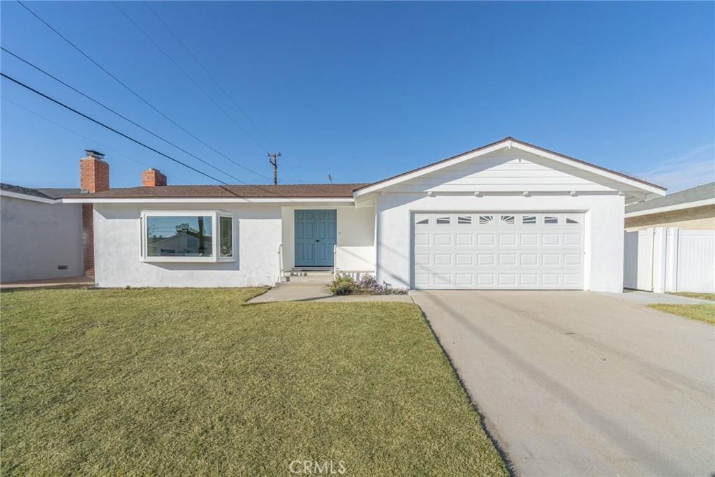 ranch-style house with a garage and a front yard