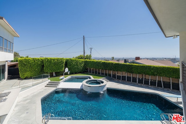 view of swimming pool with an in ground hot tub