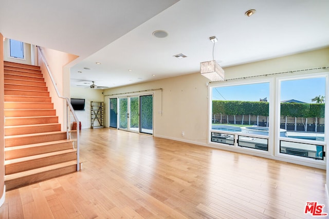 unfurnished living room featuring light hardwood / wood-style floors and ceiling fan