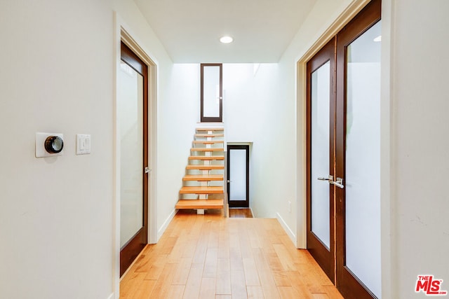 corridor with light wood-type flooring