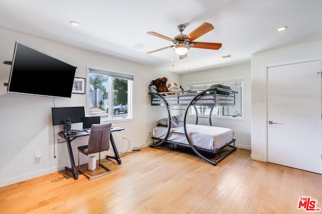 bedroom with ceiling fan and hardwood / wood-style floors