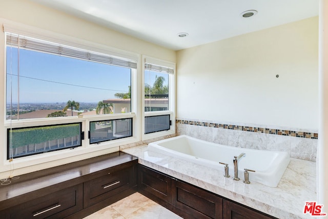 bathroom featuring tile patterned flooring and a tub to relax in