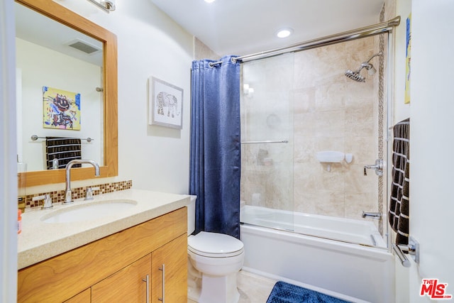 full bathroom with shower / tub combo with curtain, vanity, and toilet