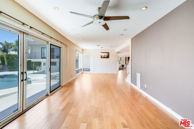 spare room with light hardwood / wood-style floors and ceiling fan