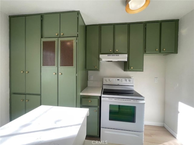 kitchen featuring white electric stove and green cabinets