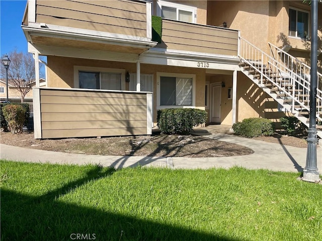 property entrance with a lawn