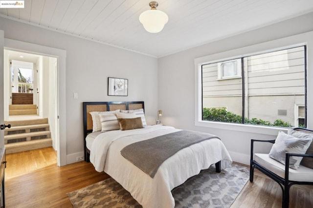 bedroom with wood-type flooring and wooden ceiling