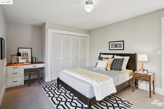 carpeted bedroom featuring built in desk and a closet