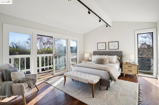 bedroom with vaulted ceiling with beams, access to outside, hardwood / wood-style floors, and rail lighting