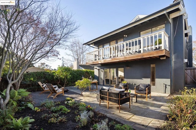 rear view of house with an outdoor hangout area and a patio area