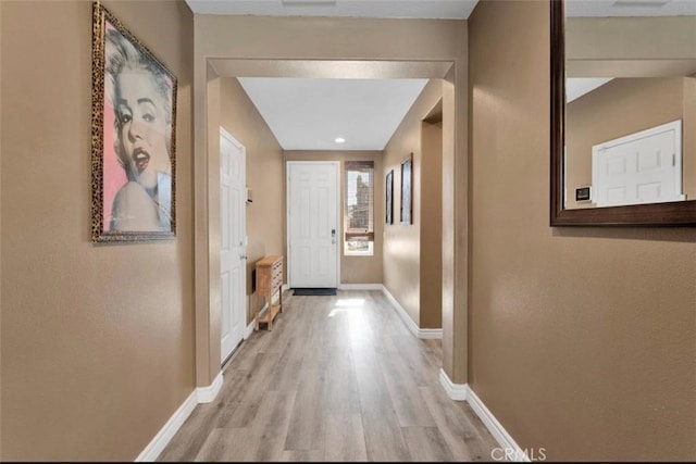 hall with light hardwood / wood-style flooring