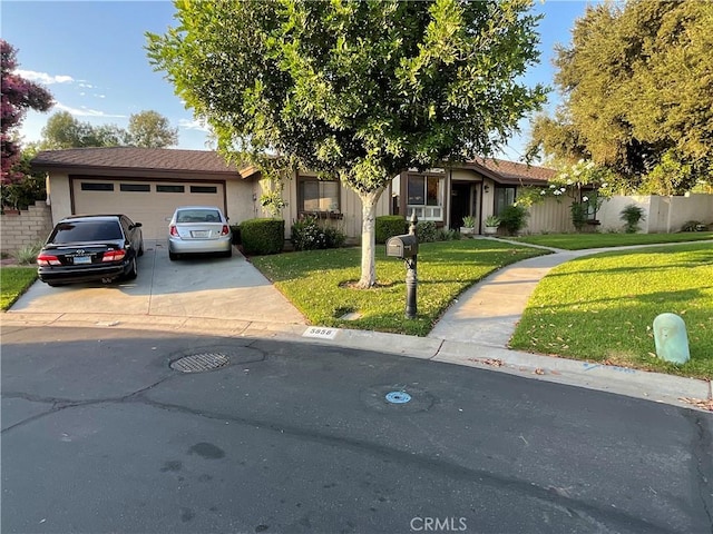 view of front of house with a garage and a front yard