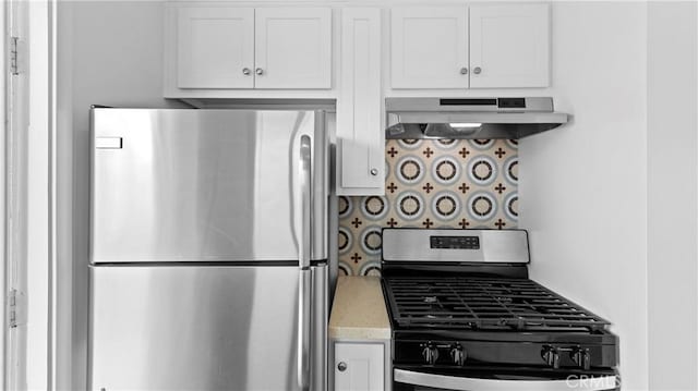 kitchen with white cabinetry, appliances with stainless steel finishes, range hood, and tasteful backsplash