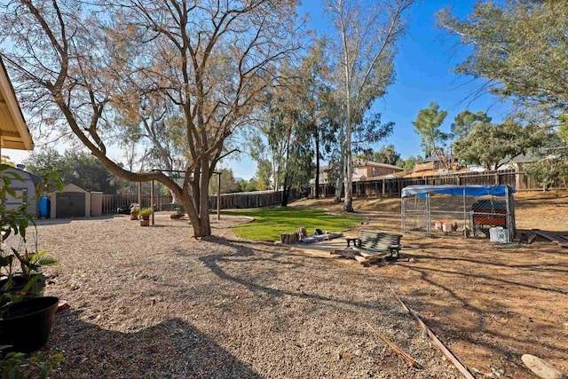 view of yard featuring a storage shed and a covered pool