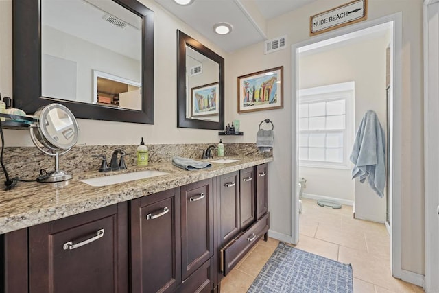 bathroom featuring vanity, toilet, and tile patterned flooring