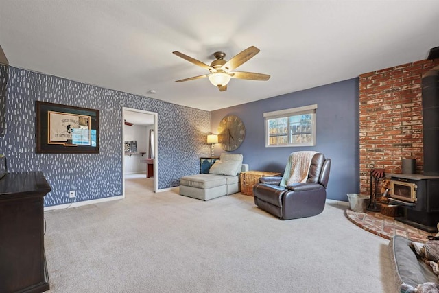 carpeted living room featuring ceiling fan and a wood stove