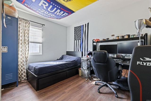 bedroom with hardwood / wood-style flooring