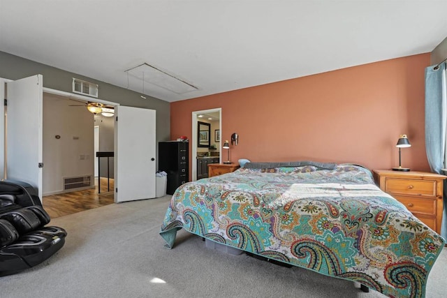 carpeted bedroom featuring visible vents and attic access